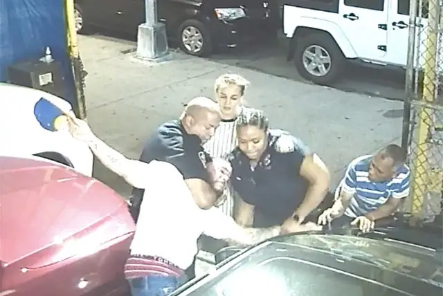 A still showing Medina being restrained by police